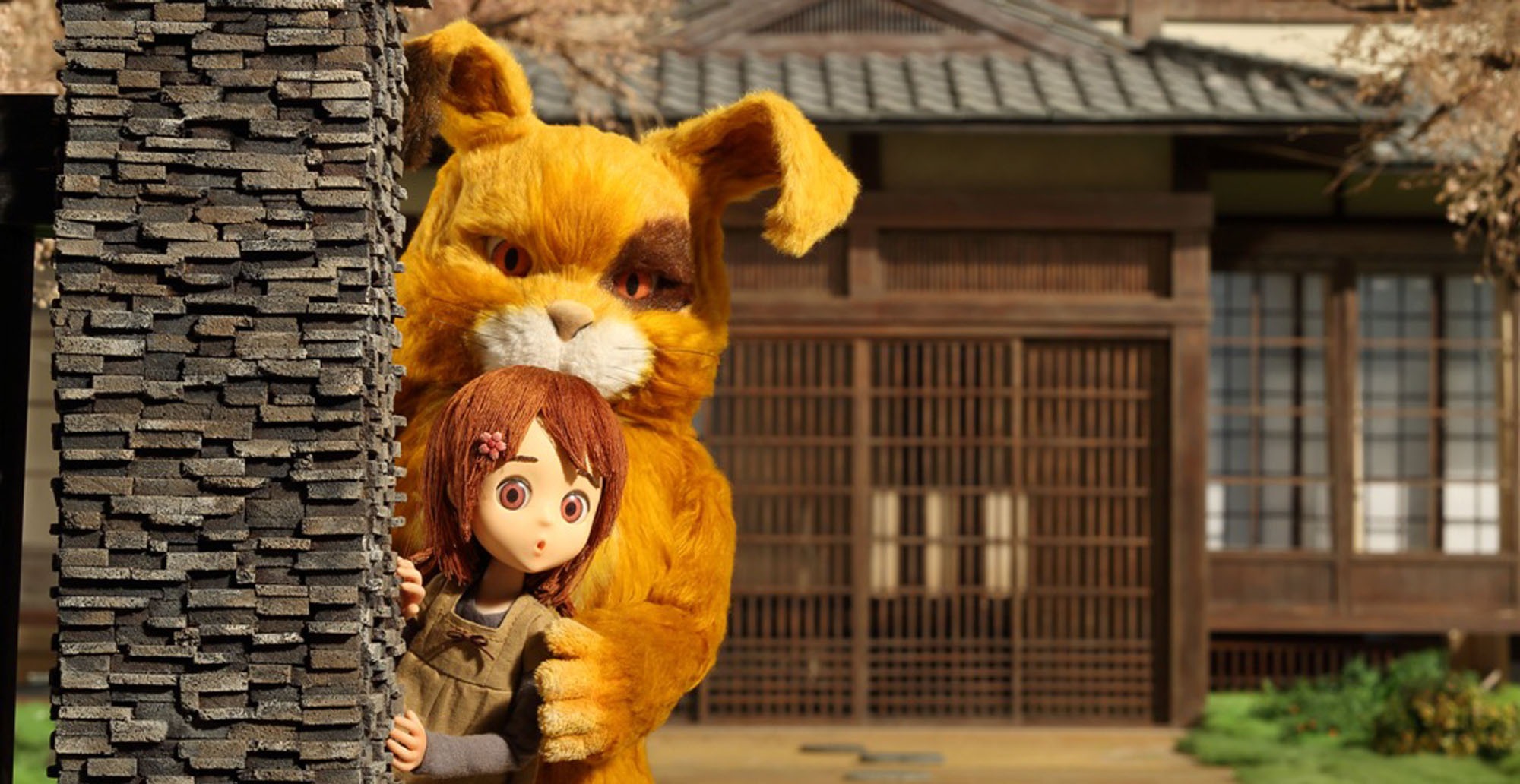 Chieri and her stuffed rabbit Cherry peeking from behind a wall